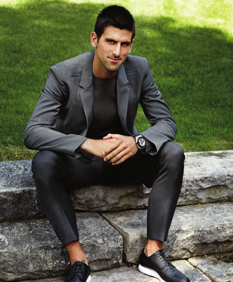 Novak Djokovic poses a picture in a black suit.